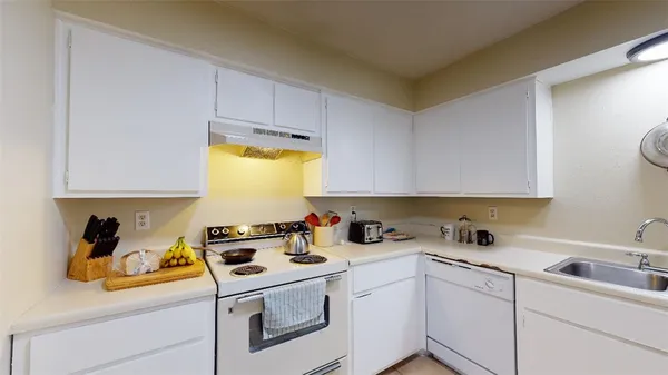 a view of a kitchen with sink and cabinets