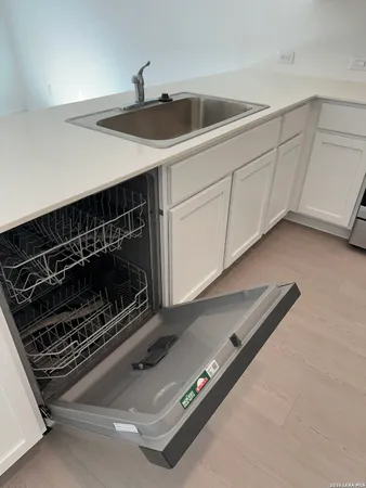 a stove top oven sitting inside of a kitchen