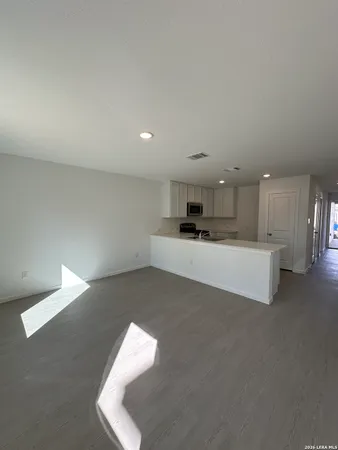 a living room with furniture and kitchen view