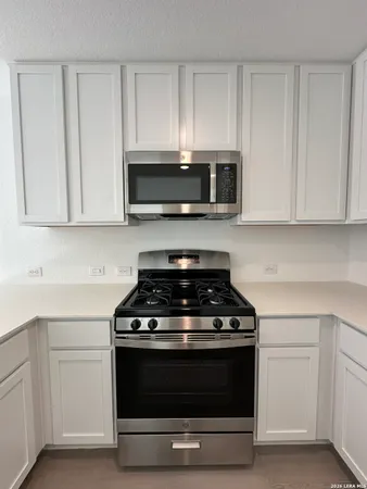 a stove top oven sitting inside of a kitchen