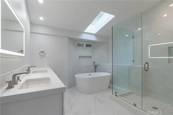 a bathroom with a double vanity sink mirror and shower