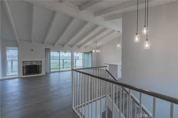 a view of empty room with wooden floor and fireplace