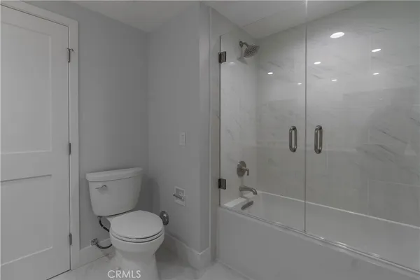 a bathroom with a toilet and shower