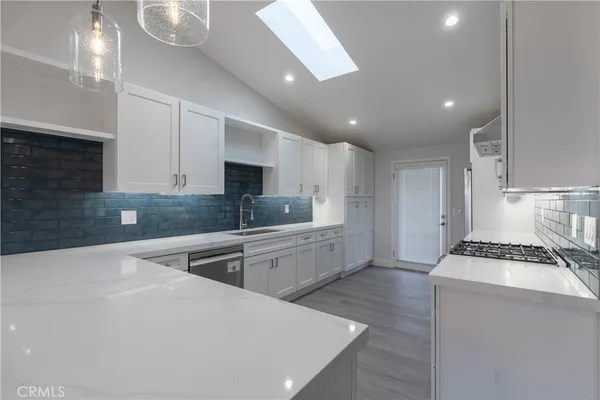 a kitchen with a stove a sink and a refrigerator