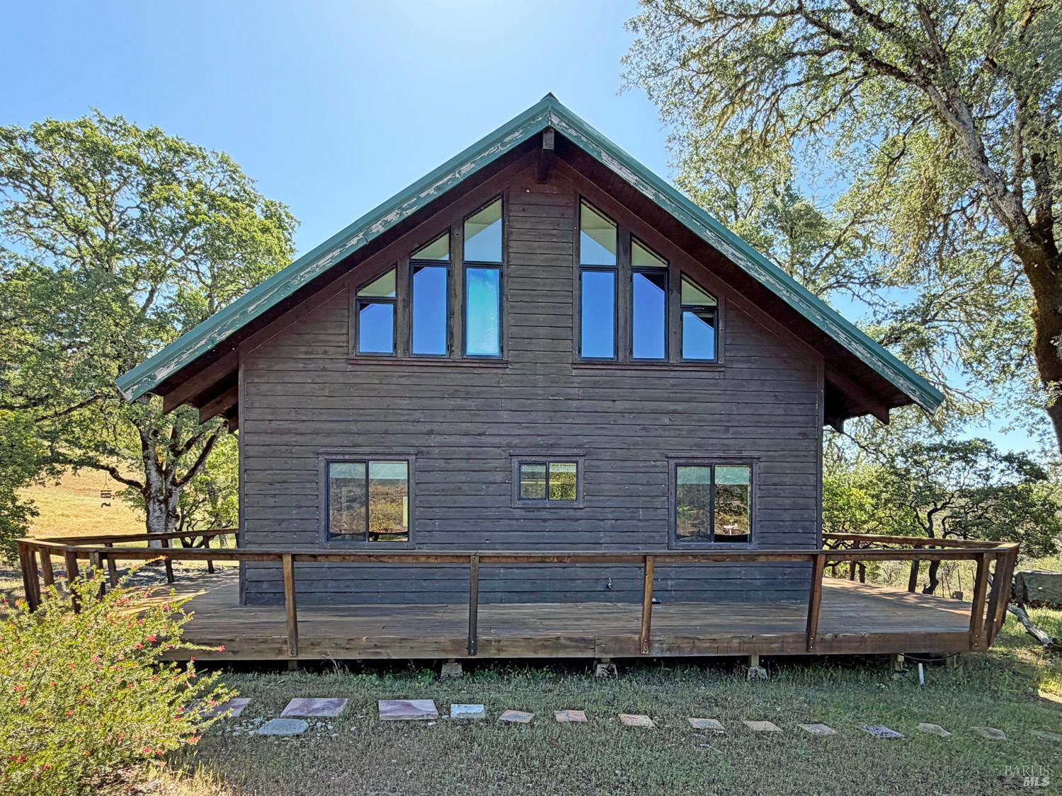 31312 High Point Road Potter Valley, CA 95469 - Photo 7 of 58 a view of a wooden house with a yard