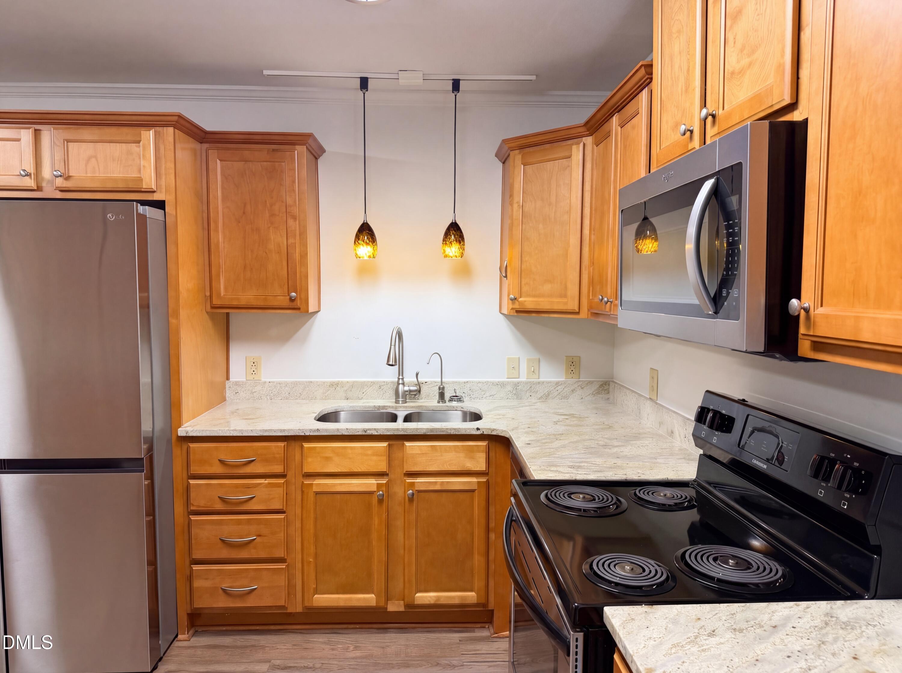 102 Lakeside Farm Road Zebulon, NC 27597 - Photo 7 of 18 a kitchen with stainless steel appliances granite countertop a stove a sink and a refrigerator
