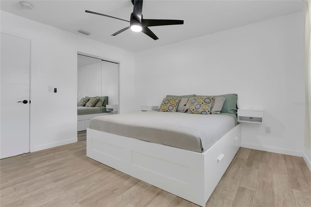 851 Darwin Drive Altamonte Springs, FL 32701 - Photo 12 of 31 a bedroom with a bed and ceiling fan