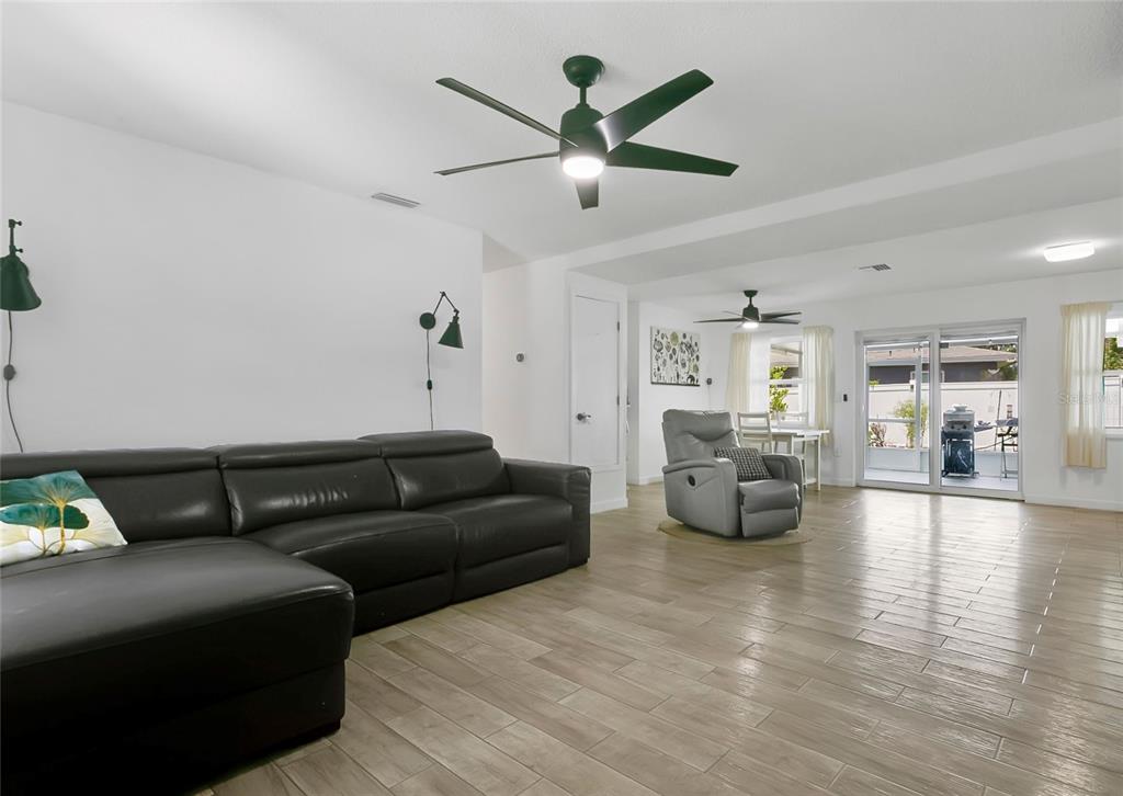 851 Darwin Drive Altamonte Springs, FL 32701 - Photo 3 of 31 a living room with furniture and a large window with garden view