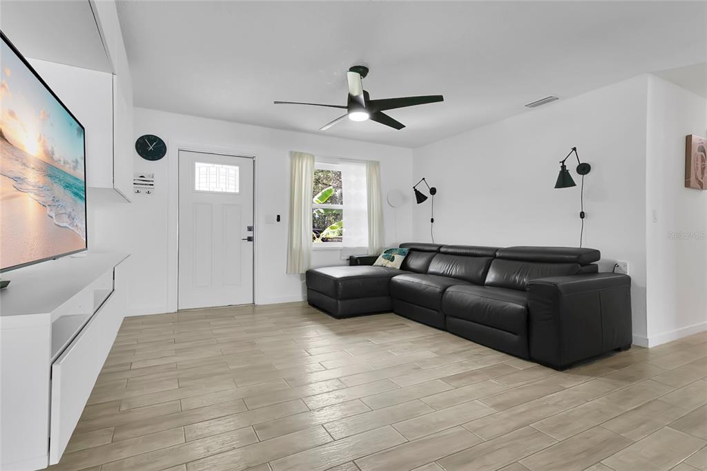 851 Darwin Drive Altamonte Springs, FL 32701 - Photo 4 of 31 a living room with furniture and a large window