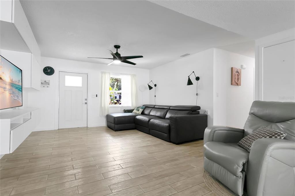 851 Darwin Drive Altamonte Springs, FL 32701 - Photo 5 of 31 a living room with furniture and a wooden floor