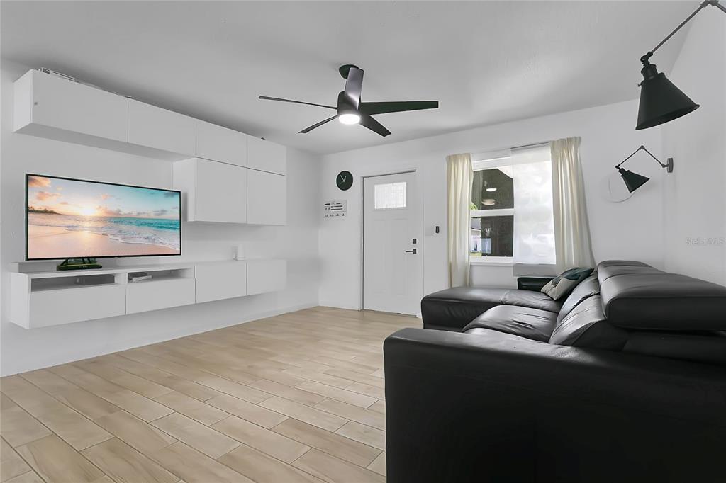 851 Darwin Drive Altamonte Springs, FL 32701 - Photo 6 of 31 a living room with furniture and a flat screen tv