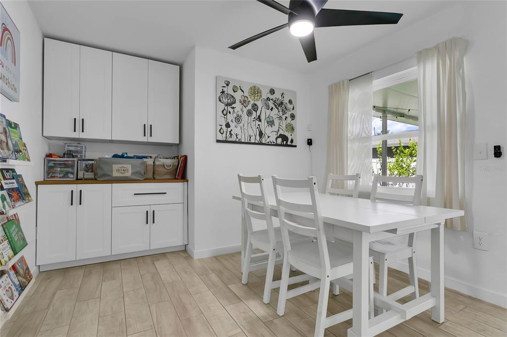 851 Darwin Drive Altamonte Springs, FL 32701 - Photo 8 of 31 a kitchen with stainless steel appliances kitchen island granite countertop a dining table chairs and white cabinets