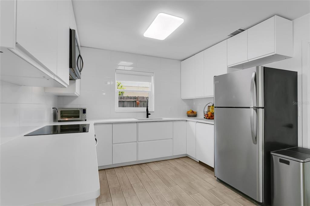 851 Darwin Drive Altamonte Springs, FL 32701 - Photo 9 of 31 a kitchen with stainless steel appliances a refrigerator sink and microwave