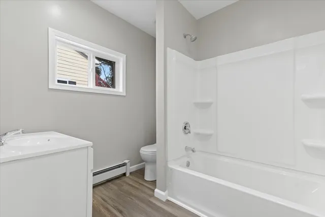 a bathroom with a toilet and a bathtub