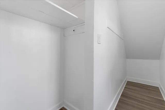 a view of hallway with wooden floor