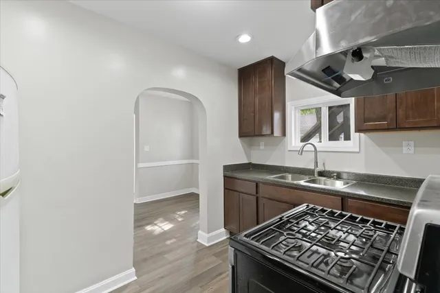 a kitchen with wooden cabinets and a stove top oven