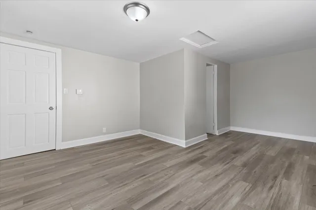 a view of an empty room with wooden floor