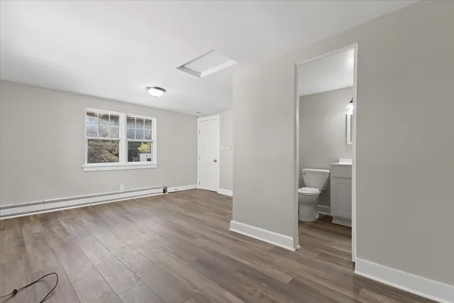 a view of a room with wooden floor and window