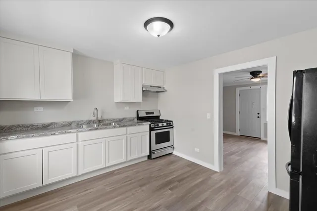 a kitchen with stainless steel appliances granite countertop a stove and a refrigerator
