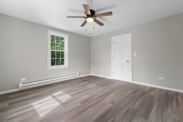 wooden floor in an empty room with a window