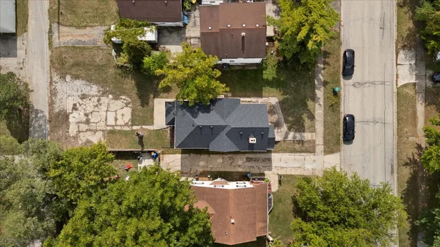 an aerial view of a house with a yard and garden