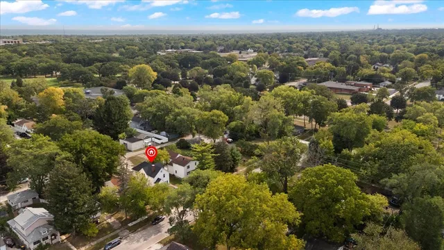 an aerial view of a houses with a yard