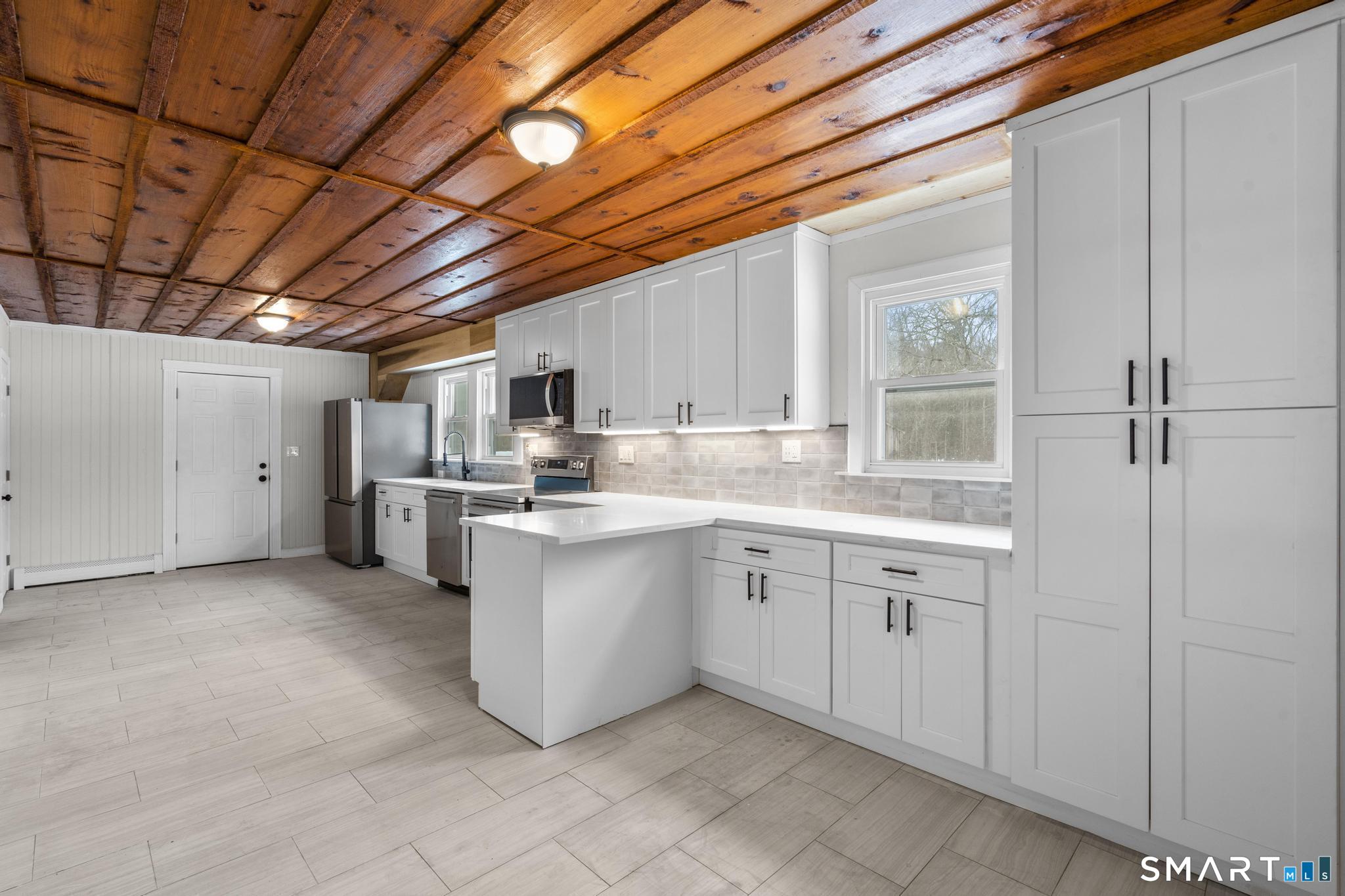 165 Ballamahack Road Windham, CT 06280 - Photo 12 of 40 a kitchen that has a lot of cabinets in it and appliances