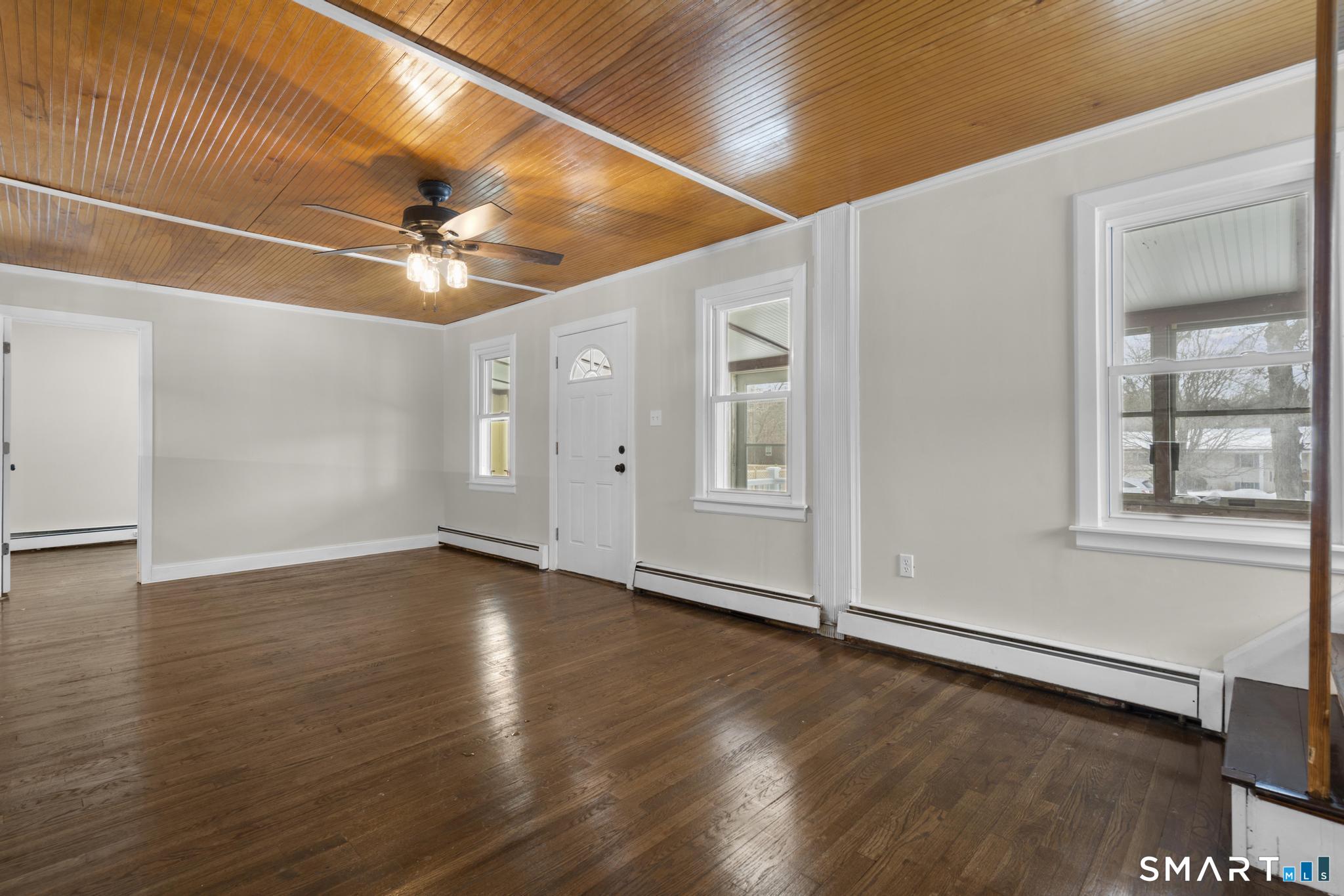165 Ballamahack Road Windham, CT 06280 - Photo 16 of 40 an empty room with wooden floor fan and windows