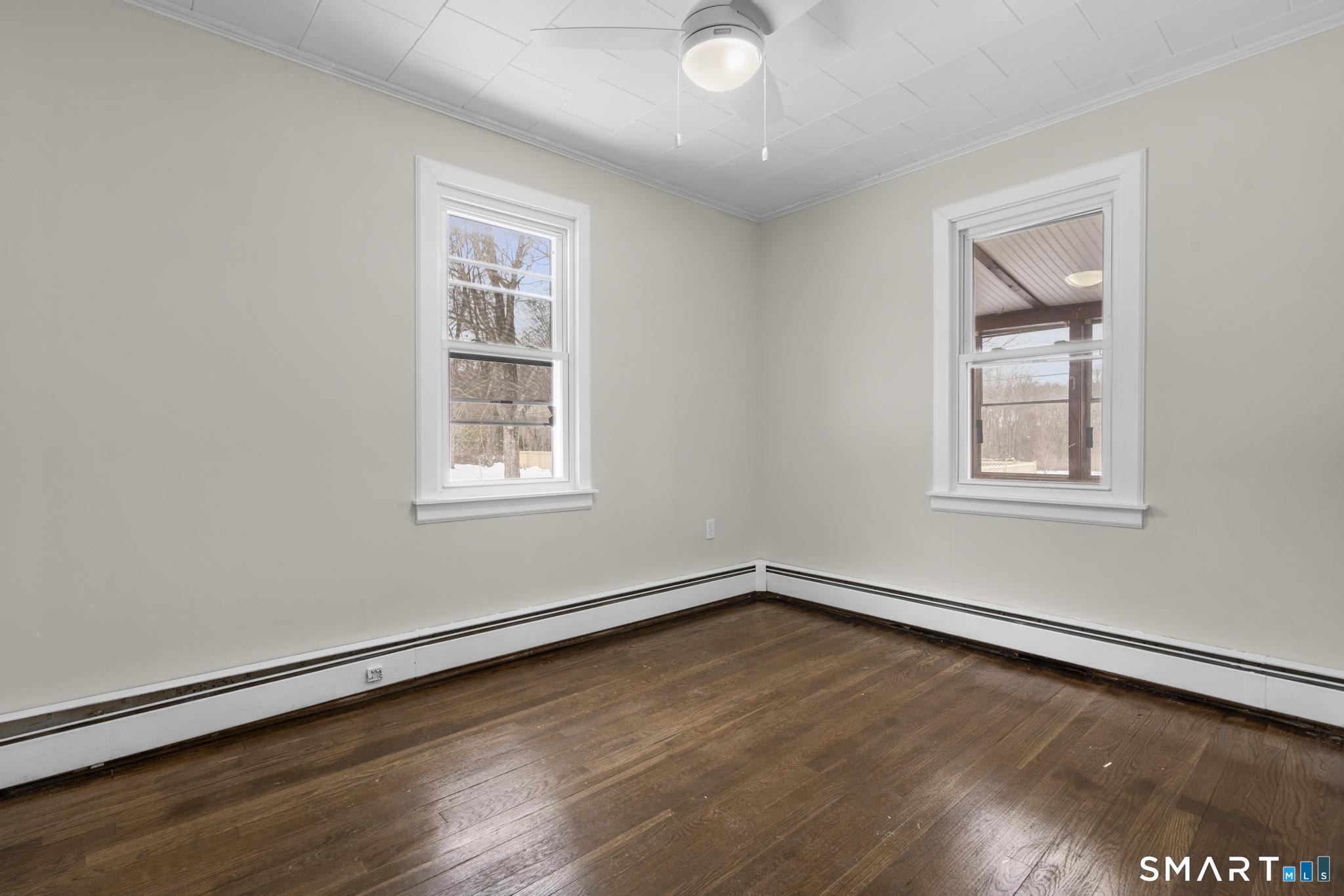 165 Ballamahack Road Windham, CT 06280 - Photo 20 of 40 a view of a room with wooden floor and windows