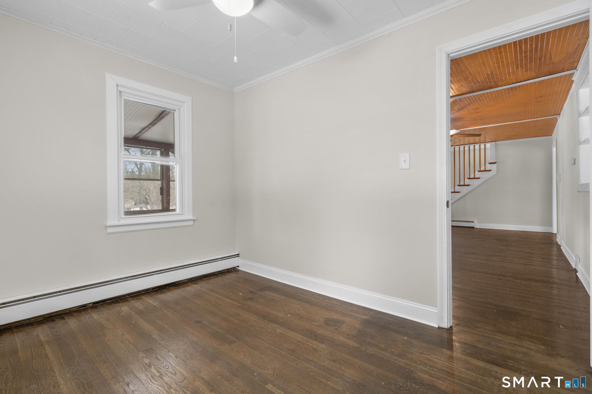 165 Ballamahack Road Windham, CT 06280 - Photo 21 of 40 an empty room with wooden floor and windows