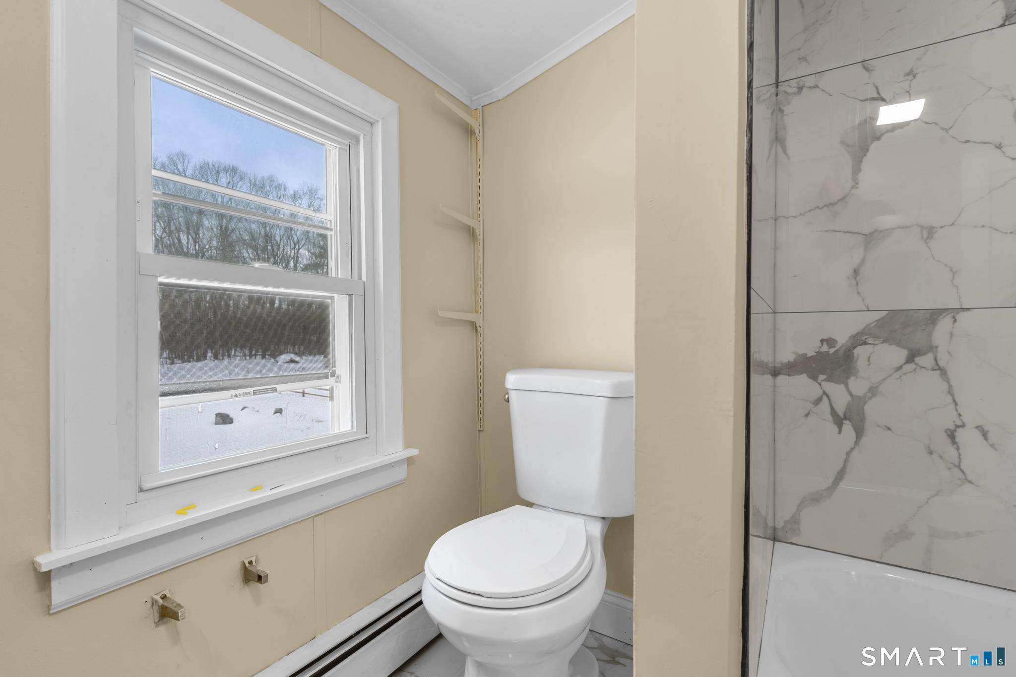 165 Ballamahack Road Windham, CT 06280 - Photo 28 of 40 a white toilet sitting next to a bathroom sink