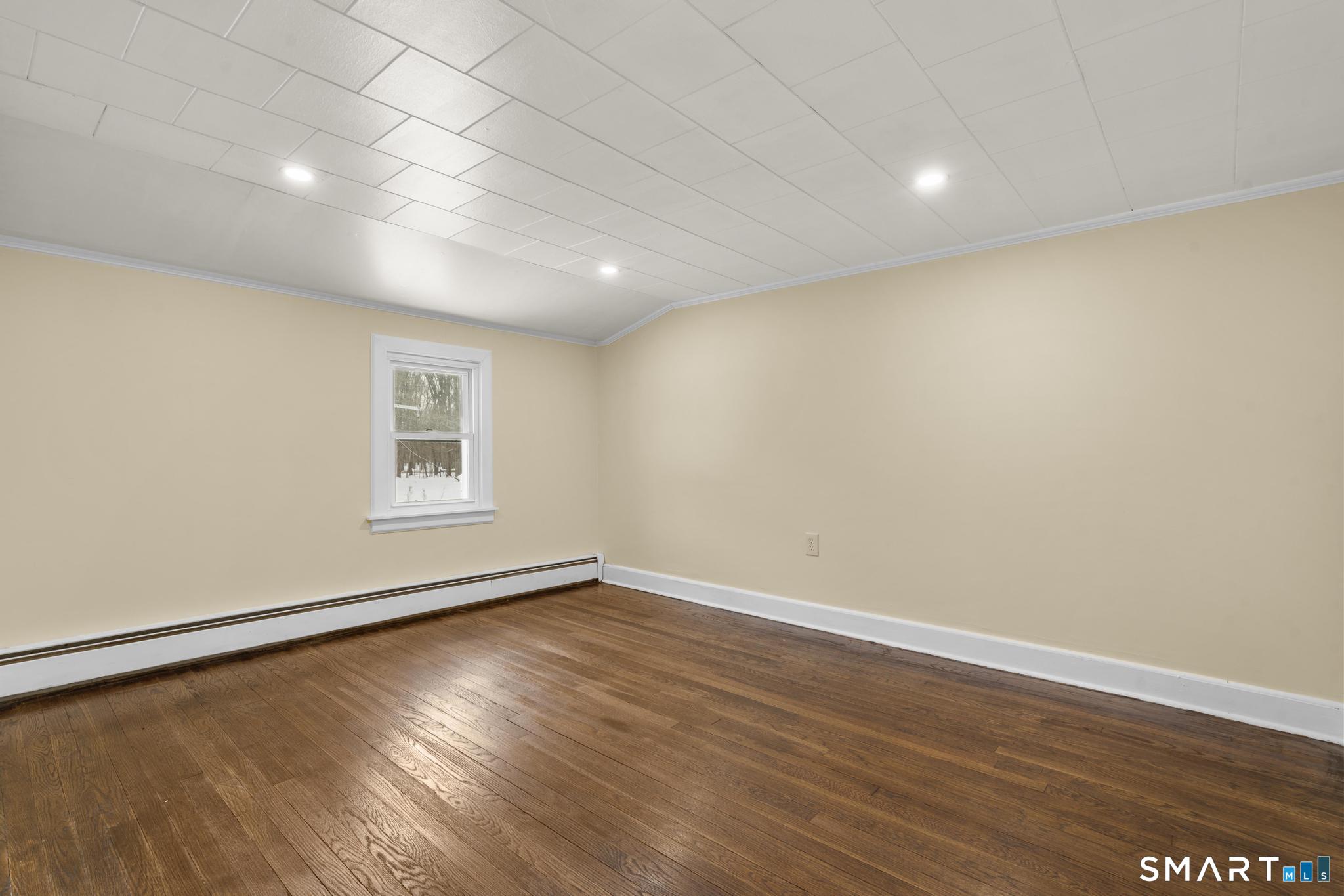 165 Ballamahack Road Windham, CT 06280 - Photo 29 of 40 an empty room with wooden floor and windows