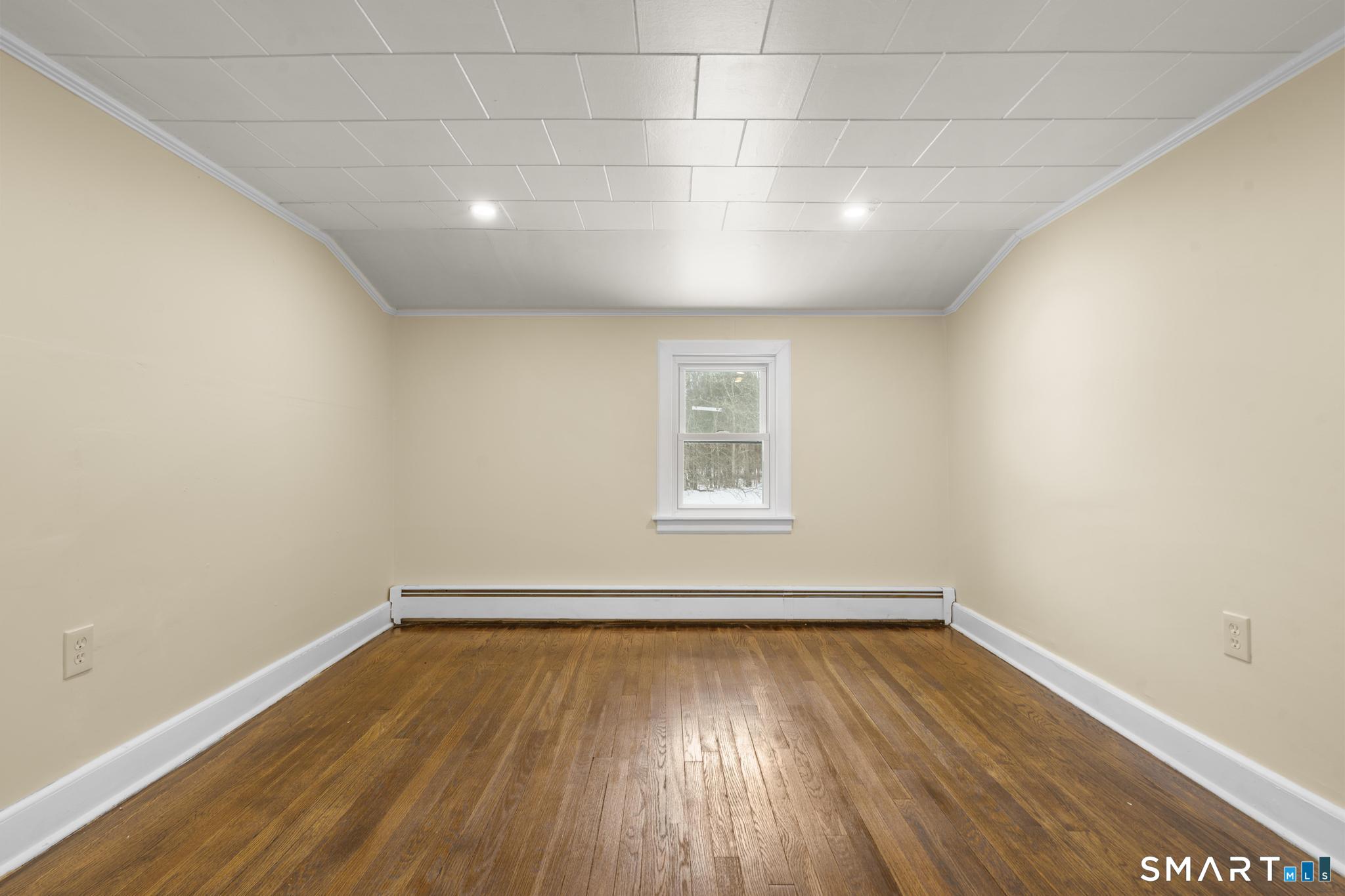 165 Ballamahack Road Windham, CT 06280 - Photo 30 of 40 a view of empty room with wooden floor and fan