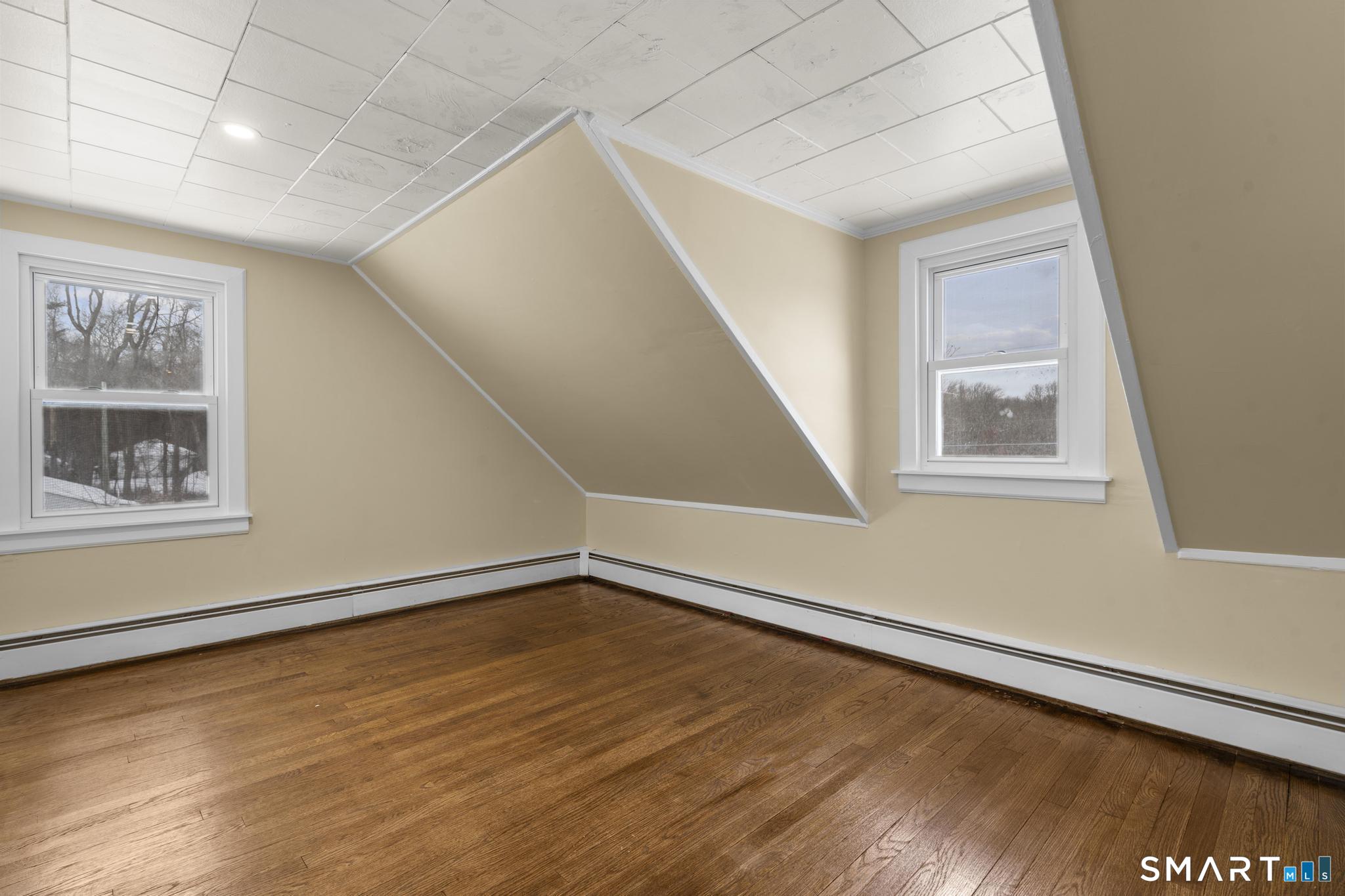 165 Ballamahack Road Windham, CT 06280 - Photo 32 of 40 a view of an empty room with wooden floor and a window