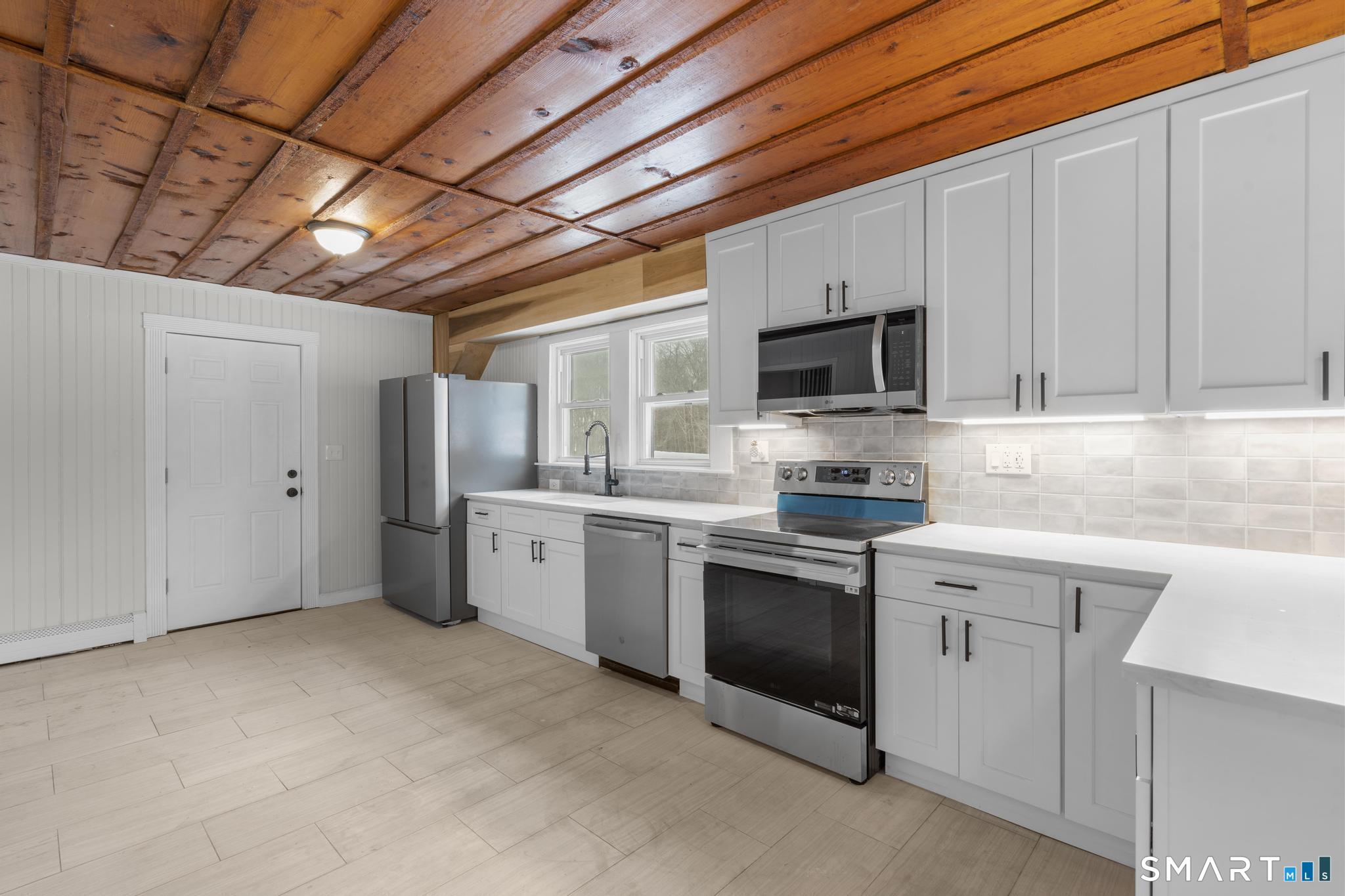 165 Ballamahack Road Windham, CT 06280 - Photo 7 of 40 a kitchen with refrigerator stove microwave and sink