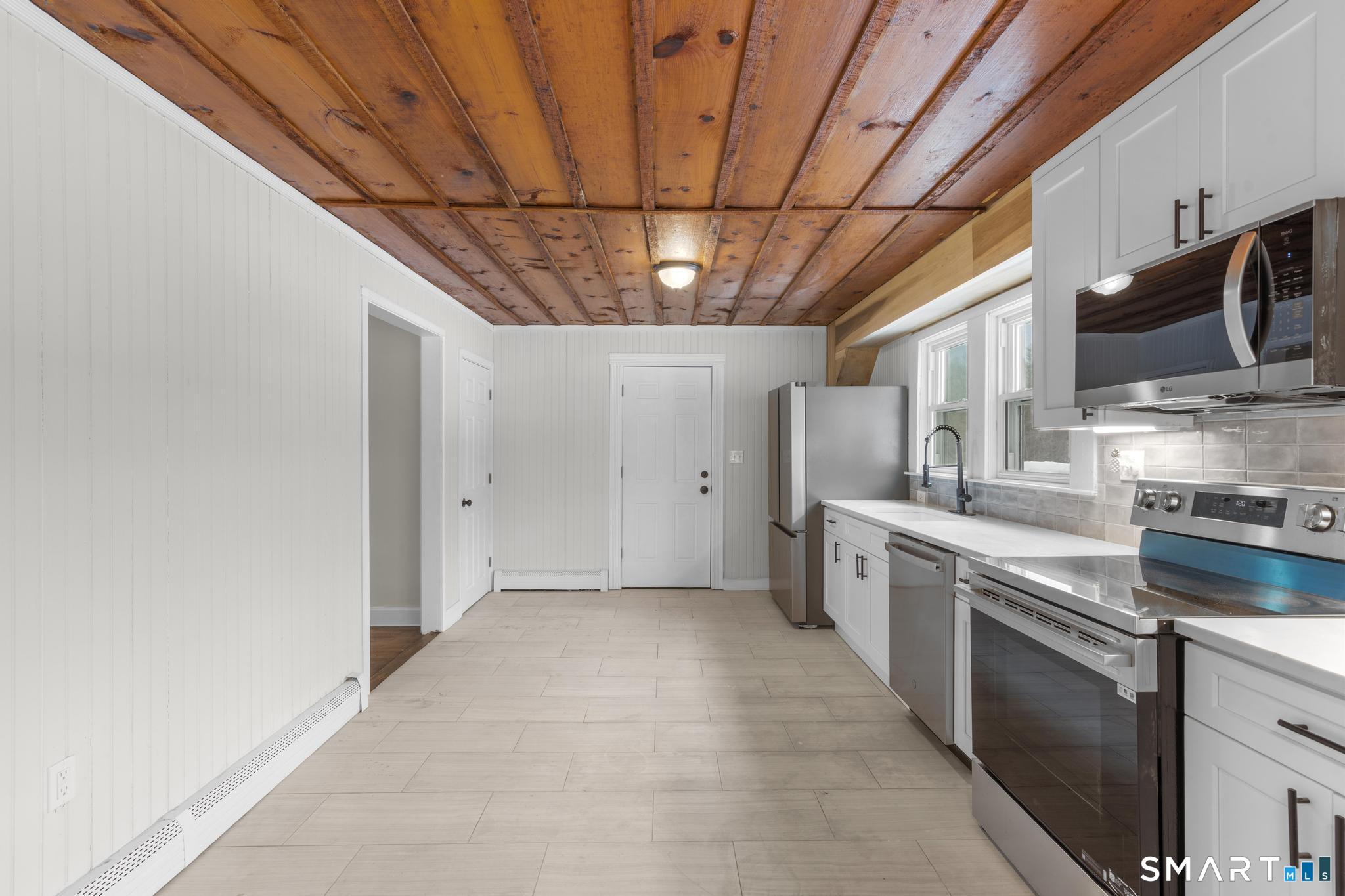 165 Ballamahack Road Windham, CT 06280 - Photo 10 of 40 a kitchen with stainless steel appliances granite countertop a sink a stove and cabinets