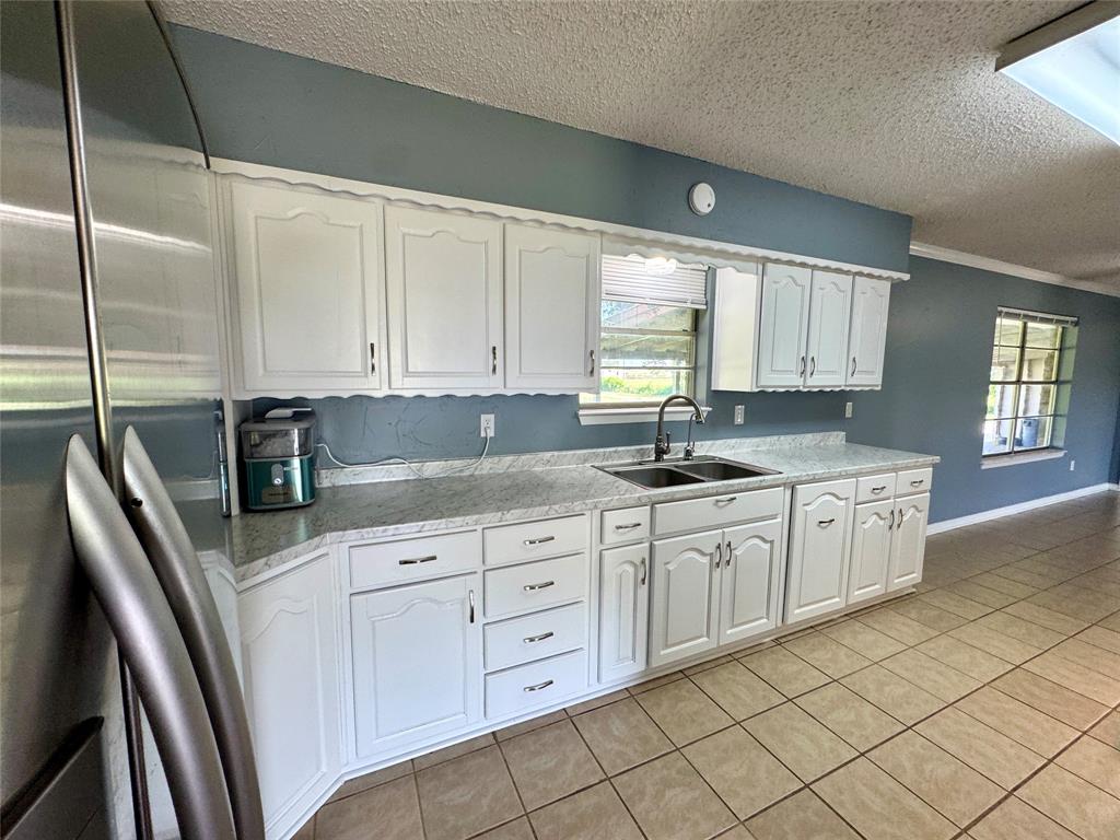 4170 Farm To Market 51 Decatur, TX 76234 - Photo 17 of 34 a kitchen with granite countertop white cabinets and white appliances