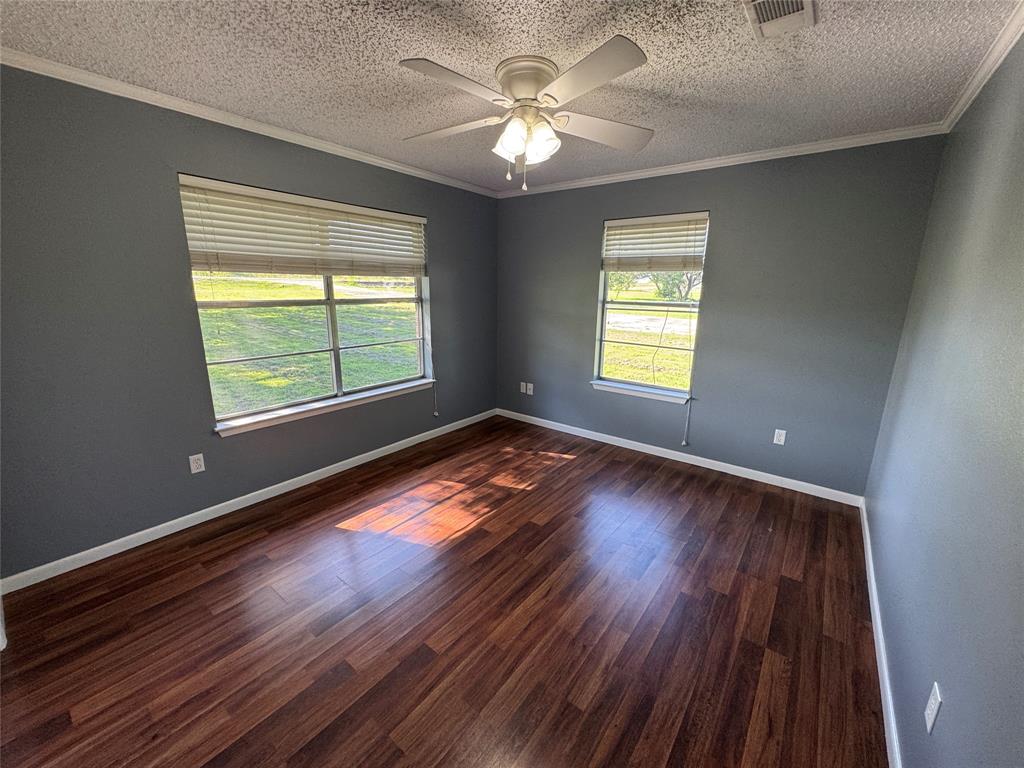 4170 Farm To Market 51 Decatur, TX 76234 - Photo 23 of 34 a view of an empty room with wooden floor and a window