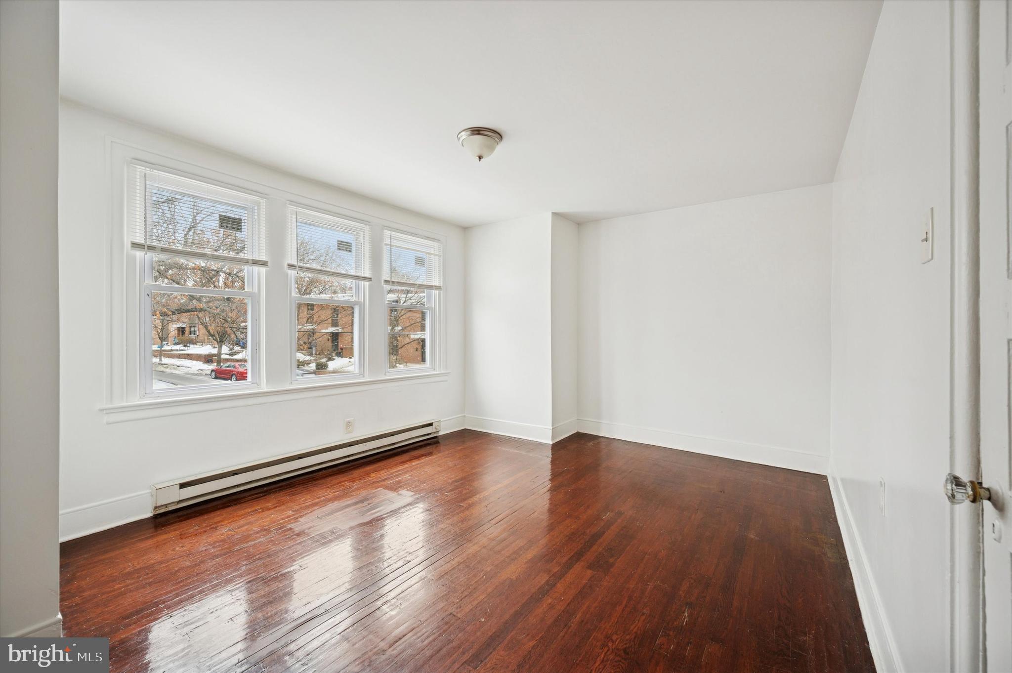 2000 Widener Place, Unit 1 Philadelphia, PA 19138 - Photo 11 of 15 an empty room with wooden floor and windows