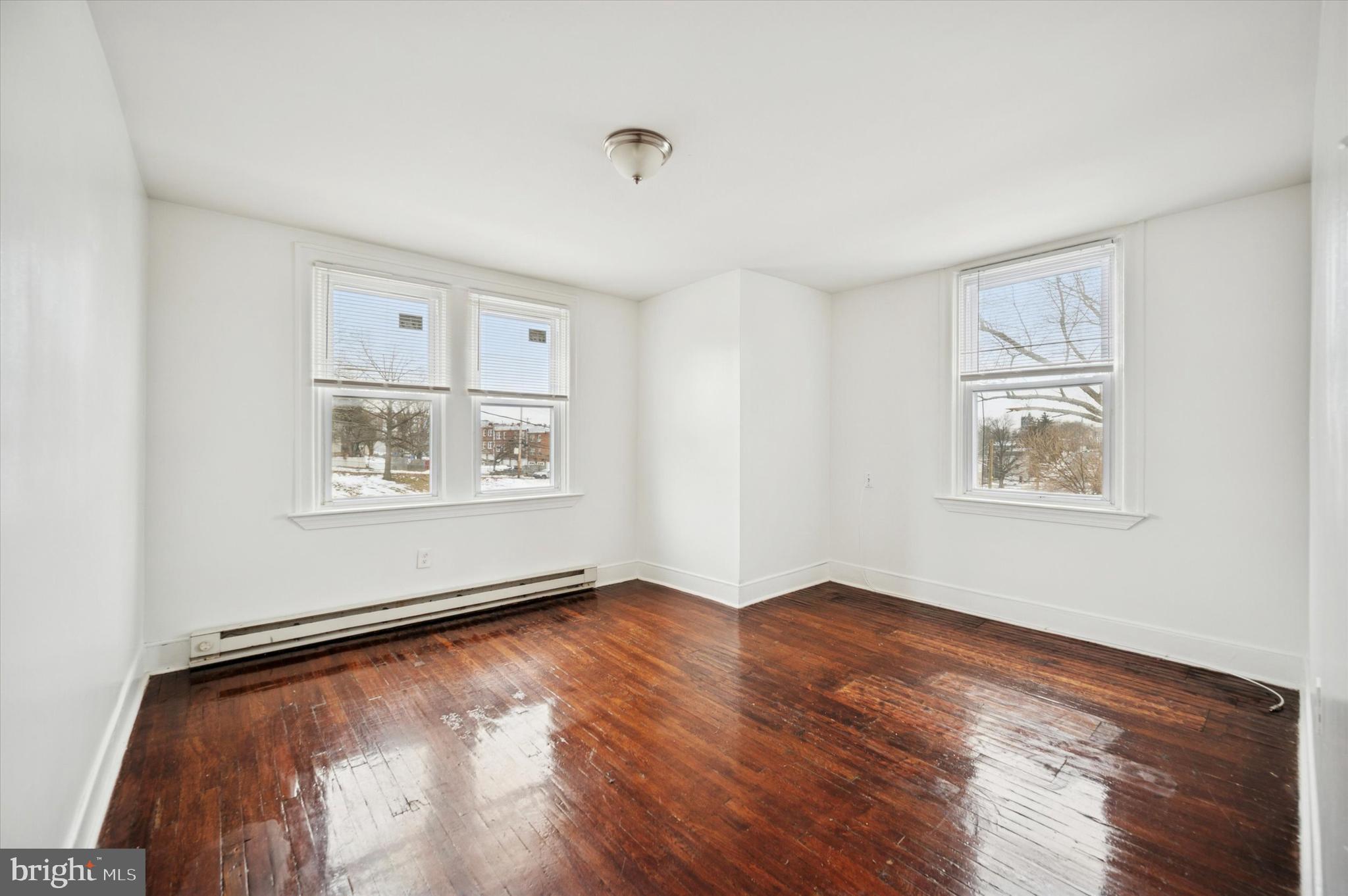 2000 Widener Place, Unit 1 Philadelphia, PA 19138 - Photo 4 of 15 a view of an empty room with window and wooden floor