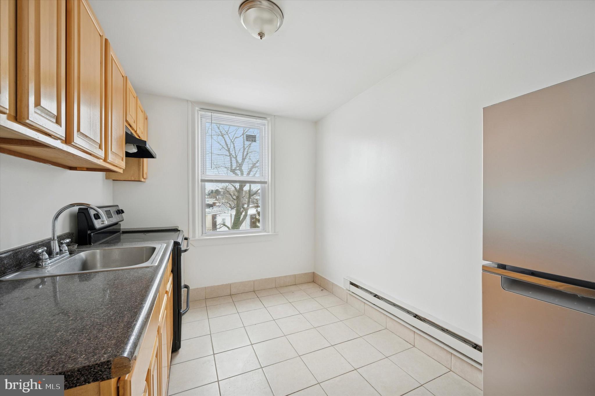 2000 Widener Place, Unit 1 Philadelphia, PA 19138 - Photo 7 of 15 a kitchen with stainless steel appliances granite countertop a sink a stove and a refrigerator