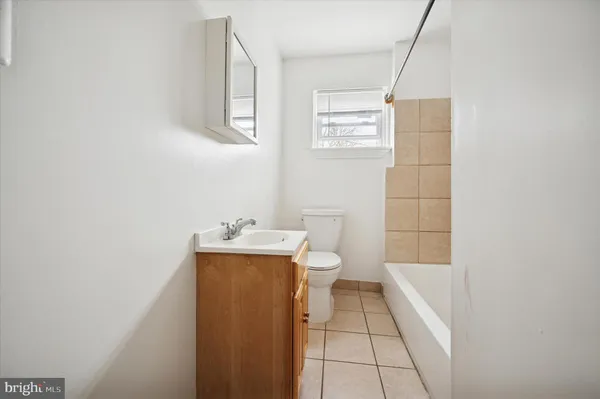 a bathroom with a toilet a sink a shower and mirror