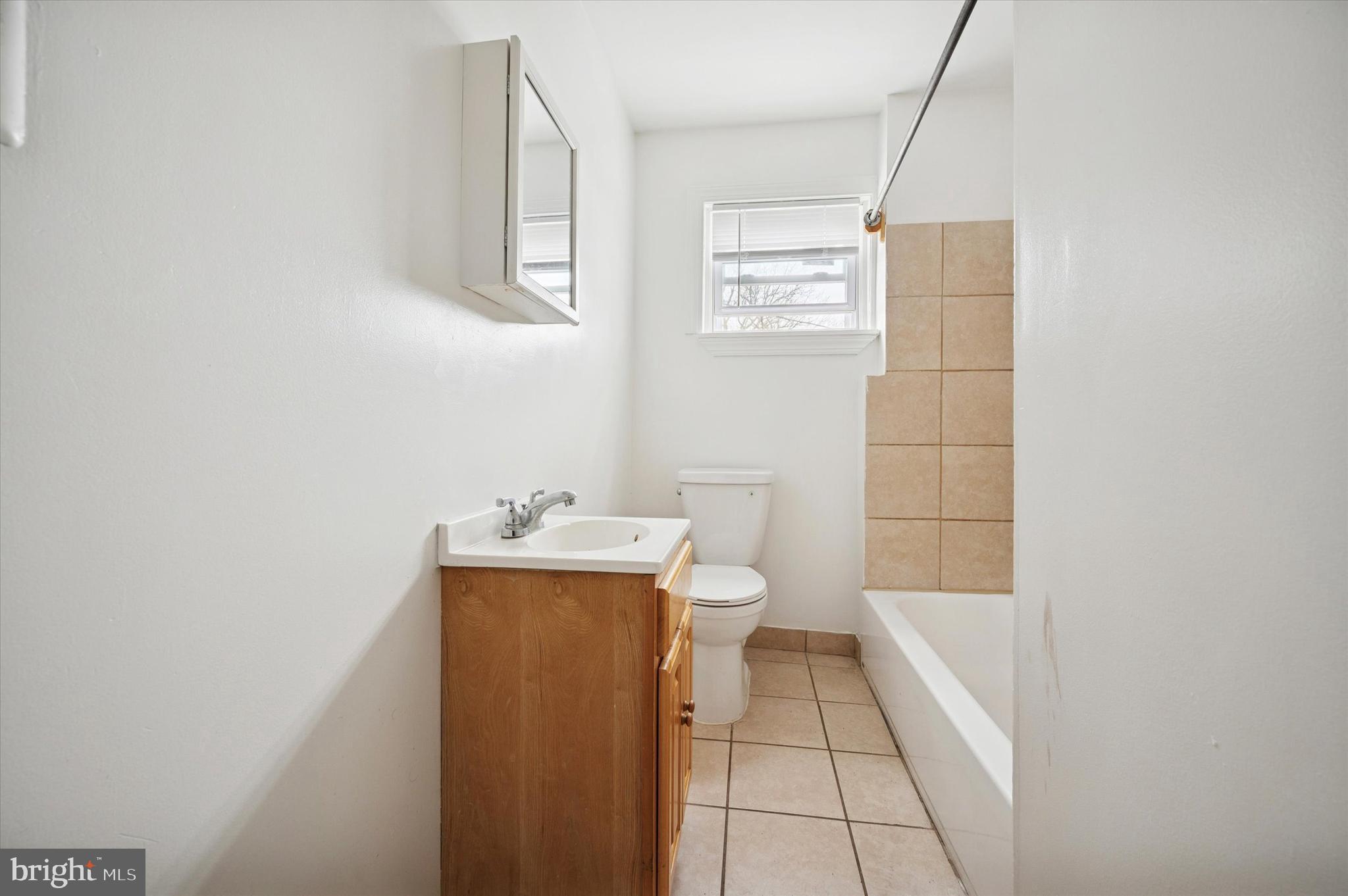 2000 Widener Place, Unit 1 Philadelphia, PA 19138 - Photo 10 of 15 a bathroom with a toilet a sink a shower and mirror