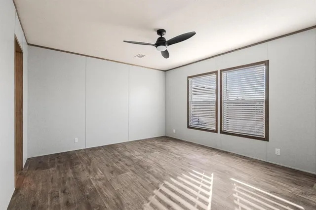 a view of a livingroom with a ceiling fan and window