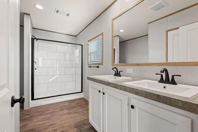 a bathroom with a double vanity sink and a mirror