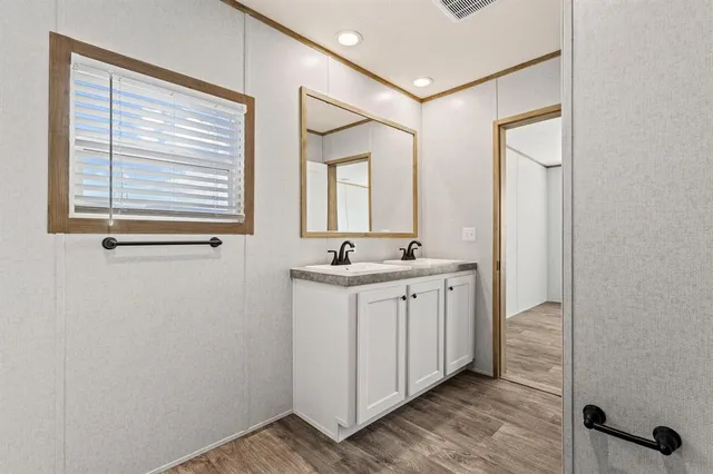 a bathroom with a double vanity sink and mirror