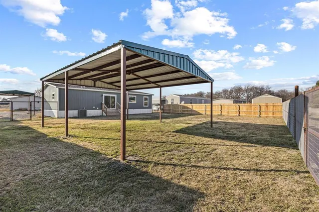 a view of a house with backyard and porch