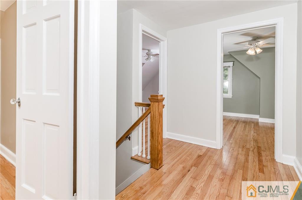 127 Plainsboro Road Cranbury, NJ 08512 - Photo 15 of 25 a view of a hallway with wooden floor and staircase