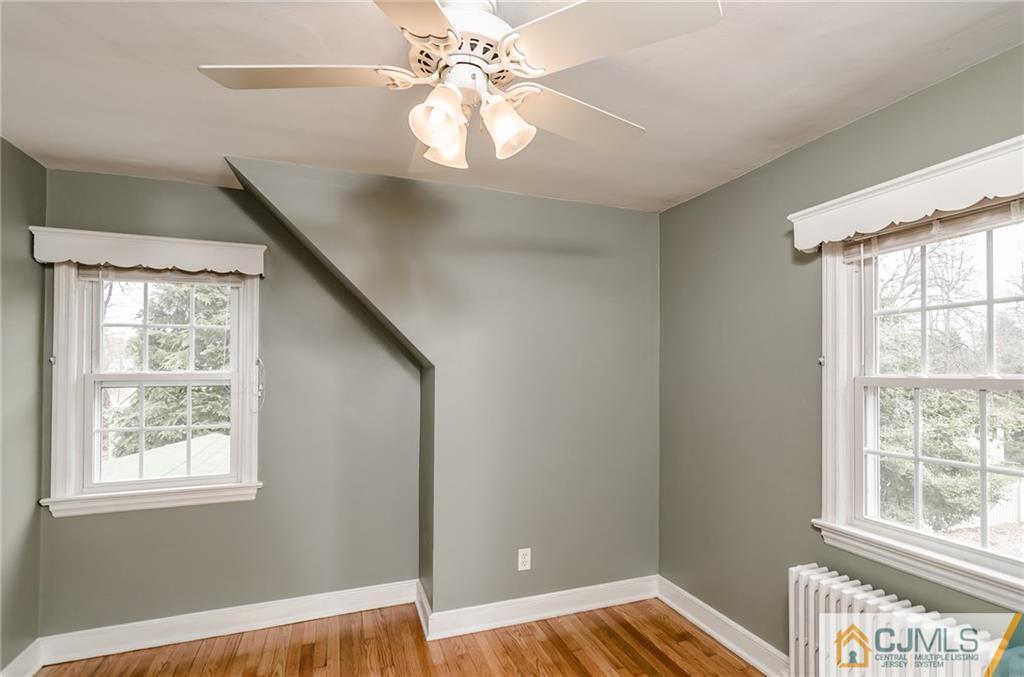 127 Plainsboro Road Cranbury, NJ 08512 - Photo 16 of 25 a view of an empty room with wooden floor and a window