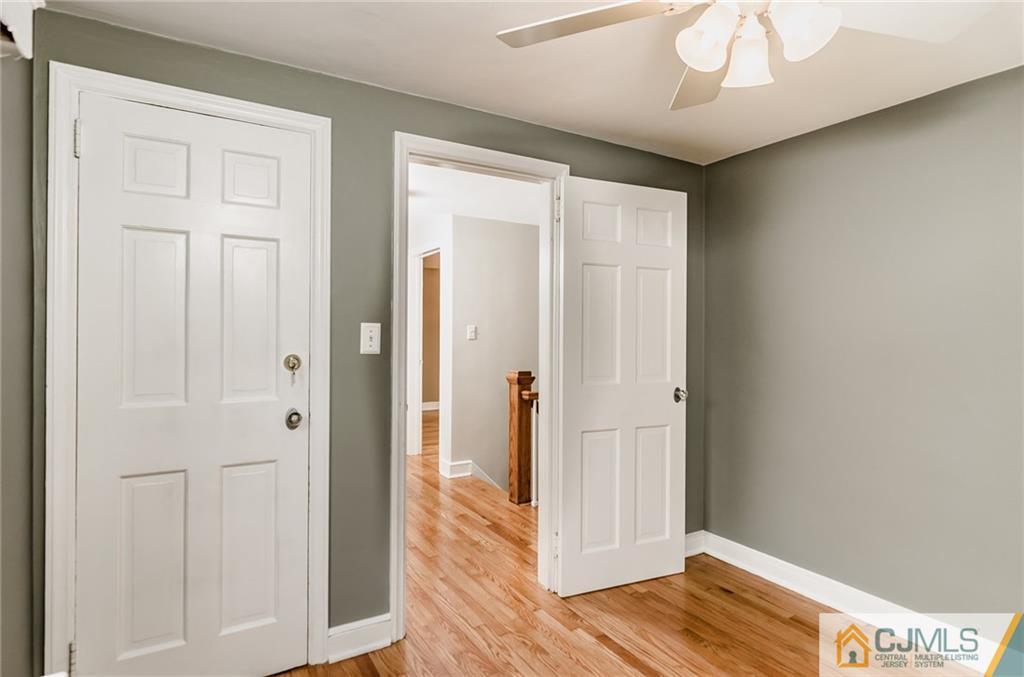 127 Plainsboro Road Cranbury, NJ 08512 - Photo 17 of 25 a view of a hallway with wooden floor